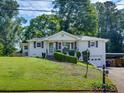 Inviting home with a spacious front yard, attached garage, and classic design at 3215 Woodview Se Dr, Smyrna, GA 30082