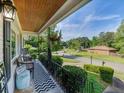 Relaxing covered front porch with chairs overlooking the landscaped yard at 3215 Woodview Se Dr, Smyrna, GA 30082