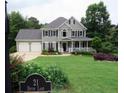 Beautiful two-story home on Devin Lane boasts a manicured lawn, lush landscaping, and a classic design at 21 Devin Lane Ln, Euharlee, GA 30145