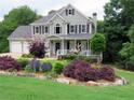 Inviting two-story home with a covered porch and an artistically landscaped yard on a well-maintained lawn at 21 Devin Lane Ln, Euharlee, GA 30145