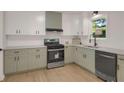 Well-equipped kitchen features sleek appliances, attractive cabinets, and modern fixtures at 589 Wilmont Dr, Jonesboro, GA 30238