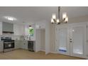 Well-lit kitchen featuring modern appliances, stylish cabinets, and a view to the outside at 589 Wilmont Dr, Jonesboro, GA 30238