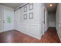 Bright foyer with wood floors, decorative trim, barn door, and ample natural light creates an inviting entrance at 100 Eldorado Dr, Carrollton, GA 30116