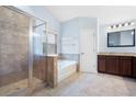Spacious bathroom with a glass shower and separate soaking tub at 130 Bevington Ln, Woodstock, GA 30188