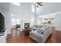 Bright living room with vaulted ceilings, hardwood floors, a fireplace, and an open floor plan at 130 Bevington Ln, Woodstock, GA 30188