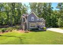 Charming two-story home features a well-manicured lawn and lush, mature trees in a private setting at 194 Saddleridge Dr, Bremen, GA 30110