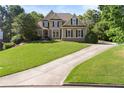 Lovely two-story home with a spacious front yard and long driveway at 4440 Green Summers Dr, Cumming, GA 30028
