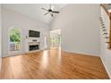 Bright living room with high ceilings, fireplace, and access to the outdoor grill at 4440 Green Summers Dr, Cumming, GA 30028