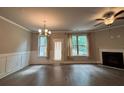 A bright, open-concept living room features lots of space, a fireplace, ceiling fan and hardwood floors at 338 Cherryhill Ln, Woodstock, GA 30188