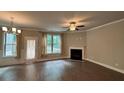 Spacious living room featuring a fireplace, ceiling fan, and large windows for ample natural light at 338 Cherryhill Ln, Woodstock, GA 30188
