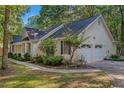 A charming ranch-style home showing the two car garage and well manicured landscaping at 360 N Oakland Circle, Mcdonough, GA 30253