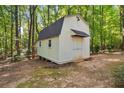 Exterior of a well-maintained shed with double doors and a window for natural light and ventilation at 360 N Oakland Circle, Mcdonough, GA 30253
