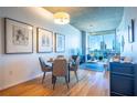 Dining area with modern lighting and views of the city skyline from large windows at 860 Peachtree Ne St # 1613, Atlanta, GA 30308