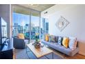 Cozy living room with modern decor and stunning cityscape views from the balcony at 860 Peachtree Ne St # 1613, Atlanta, GA 30308