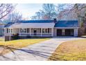 Charming single-story home featuring a covered porch, attached garage, and a well-maintained front yard at 280 Hitchcock Rd, Dallas, GA 30157