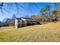 View of the side of a home, including a basement and covered porch at 280 Hitchcock Rd, Dallas, GA 30157