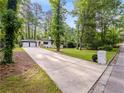 This charming home boasts a long driveway and a two-car garage at 466 Thackery Sw Pl, Atlanta, GA 30311