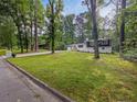 Charming home with a lush green lawn and mature trees at 466 Thackery Sw Pl, Atlanta, GA 30311