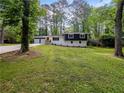 Charming home featuring a two-car garage, manicured lawn, and mature trees at 466 Thackery Sw Pl, Atlanta, GA 30311