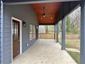 Spacious covered porch with ceiling fan and wooden railing, ideal for enjoying the outdoors at 1255 Plaza Sw Ave, Atlanta, GA 30310