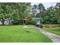 Charming single-Gathering home featuring lush front lawn, mature trees, and a welcoming exterior at 1837 Lochlomand Se Ln, Smyrna, GA 30080