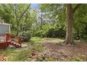 Lush backyard with mature trees, ground cover and a red deck at 1864 Madrona Nw St, Atlanta, GA 30318