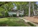 Charming single-story home with a stone accented front door and an unkept front yard at 1864 Madrona Nw St, Atlanta, GA 30318
