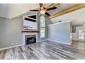 Spacious living room with vaulted ceilings, a stylish fireplace, and abundant natural light, with a glimpse into the dining area at 4751 Shay Ter, Buford, GA 30519