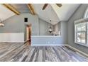 Open-concept living space with vaulted ceilings, a sleek fireplace, and a seamless transition to other living areas and dining space at 4751 Shay Ter, Buford, GA 30519