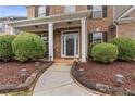Inviting front entrance with a covered porch and manicured shrubbery at 3476 Bridge Walk Drive, Lawrenceville, GA 30044