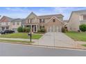 Charming brick home featuring an expansive driveway and well-maintained landscaping at 3476 Bridge Walk Drive, Lawrenceville, GA 30044
