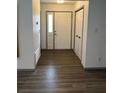 Inviting foyer features neutral paint, a large closet, and beautiful dark wood-look flooring at 5526 Stoneleigh Ct, Stone Mountain, GA 30088