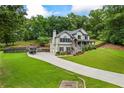 Stately two-story home with three-car garage, lush lawn, and charming front porch, perfect for Gathering gatherings and outdoor entertaining at 1301 Ficklen Church Way, Canton, GA 30114