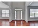 Bright foyer with gleaming hardwood floors and natural light from surrounding windows at 3805 Roxwood Park Dr, Buford, GA 30518
