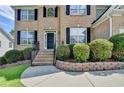 Inviting front entrance with brick steps and landscaped garden beds at 3805 Roxwood Park Dr, Buford, GA 30518