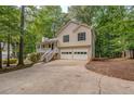 Charming two-story home with a two-car garage, a front porch, and a driveway at 459 Bakers Bridge Cir, Douglasville, GA 30134