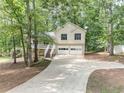 Charming two-story home with a two-car garage, a front porch, and a driveway at 459 Bakers Bridge Cir, Douglasville, GA 30134