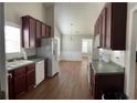 Traditional kitchen with dark wood cabinets and appliances at 802 Village Pl, Loganville, GA 30052