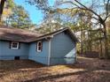 View of the side of the blue house with natural light at 125 Toccoa Rd, Carrollton, GA 30116