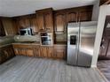 Kitchen with stainless steel appliances and dark brown cabinets at 125 Toccoa Rd, Carrollton, GA 30116
