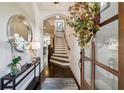 Inviting foyer with hardwood floors, stairs, and elegant decor at 502 Abbington River Ln, Atlanta, GA 30339