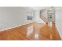 Open floor plan with hardwood floors, natural light, classic wainscoting and a staircase at 5937 Sharp Se Dr, Mableton, GA 30126