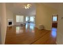 Spacious living room with hardwood floors, fireplace, and an open layout with natural light at 964 Village View Cir, Loganville, GA 30052