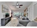 Comfortable living room with brick fireplace, built-in shelving, ceiling fan, and sliding door access to porch at 262 Somerset Ct, Lawrenceville, GA 30044