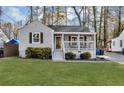 Charming home featuring a well-maintained front yard, a covered porch, and beautiful landscaping at 2912 Palm Dr, East Point, GA 30344