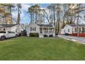 Charming home featuring a well-maintained front yard, a covered porch, and beautiful landscaping at 2912 Palm Dr, East Point, GA 30344