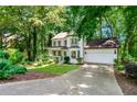 Charming two-story home featuring a two-car garage and lush green surroundings at 404 Summerchase Way, Woodstock, GA 30189