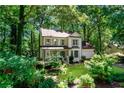 Charming two-story home with inviting porch and well-kept lawn nestled among lush, mature trees at 404 Summerchase Way, Woodstock, GA 30189