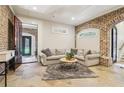 Cozy living room featuring stone floors, exposed brick, and a comfortable seating area at 5172 Roswell Rd, Marietta, GA 30062