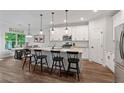 Modern kitchen with white cabinets, stainless steel appliances, and an island with bar seating at 3455 Henderson Dr, Cumming, GA 30041